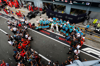 Lewis Hamilton, Mercedes AMG F1, first position, Valtteri Bottas, Mercedes AMG F1, third position, and the Mercedes team celebrate as photographers gather for a shot