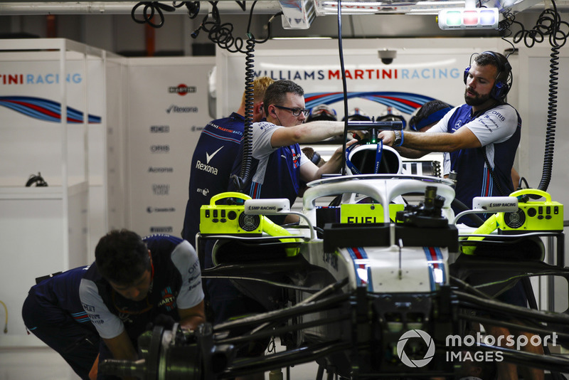 Engineers work on the car of Lance Stroll, Williams FW41