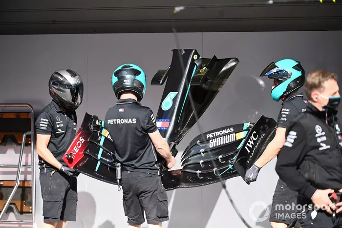 Miembros del equipo Mercedes trabajan en el coche