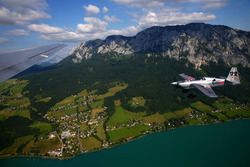 Red Bull Air Race pilot Hannes Arch flies next to the Red Bull Douglas DC-6B