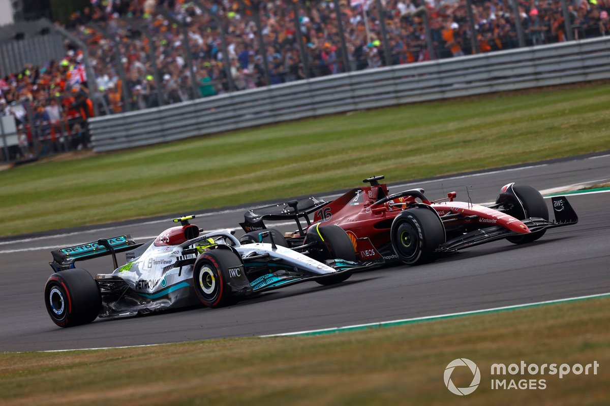 Charles Leclerc, Ferrari F1-75, battles with Lewis Hamilton, Mercedes W13