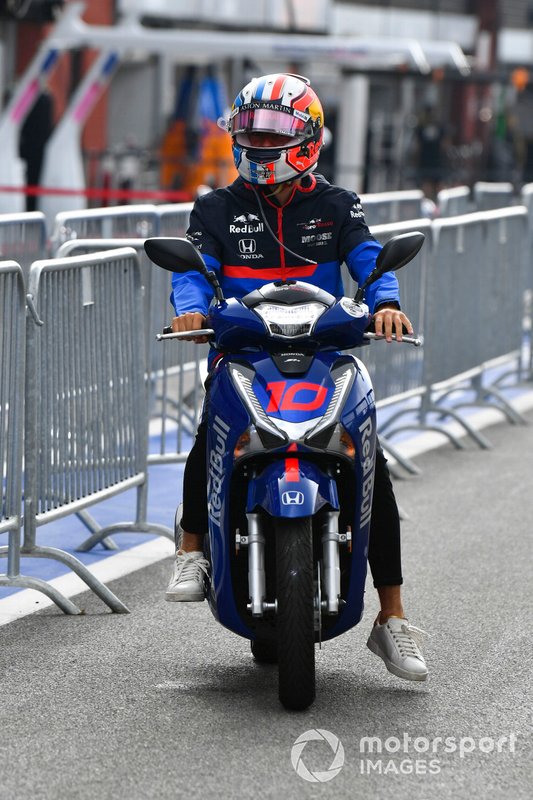 Pierre Gasly, Toro Rosso, rides a scooter