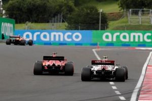 Lando Norris, McLaren MCL35, leads Sebastian Vettel, Ferrari SF1000, and Antonio Giovinazzi, Alfa Romeo Racing C39