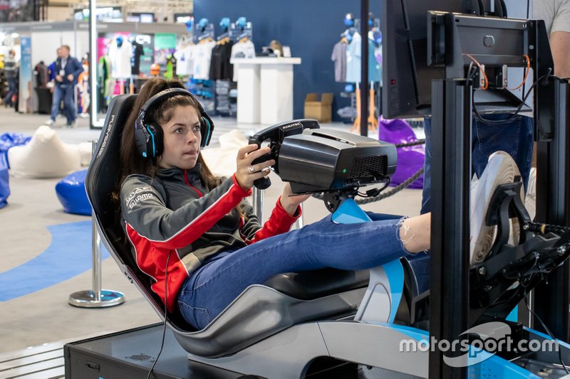 A fan uses one of the Le Mans eSports Series simulator rigs