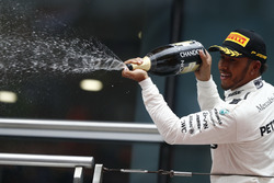 Lewis Hamilton, Mercedes AMG, sprays the victory Champagne on the podium