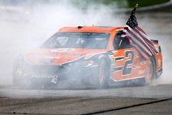 Brad Keselowski, Team Penske Ford, celebrates with a burnout after winning