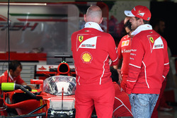 Sebastian Vettel, Ferrari looks at Ferrari SF70H with cockpit shield
