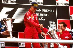 Race winner Michael Schumacher, Ferrari celebrates on the podium with team boss Jean Todt