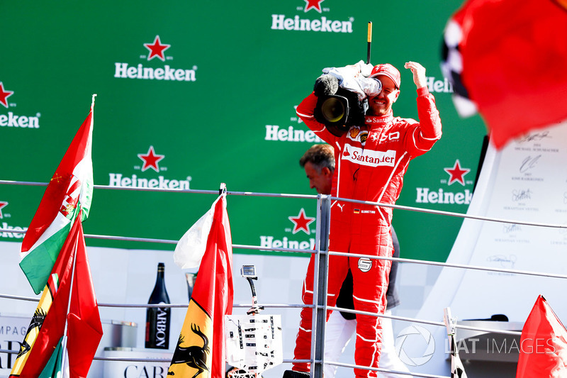 Third place Sebastian Vettel, Ferrari, borrows a TV camera to film the crowd