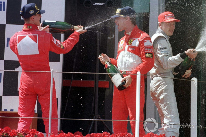 Podium: race winner Michael Schumacher, Ferrari, second place Eddie Irvine, Ferrari, third place Mika Hakkinen, McLaren