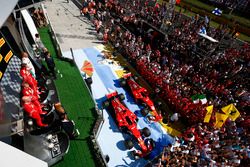 Huge crowds of team personnel gather beneath the podium to cheer for Race winner Sebastian Vettel, F