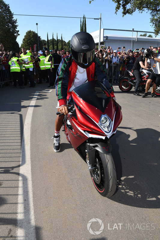 Lewis Hamilton, Mercedes AMG F1 arrives at the track on his motorbike