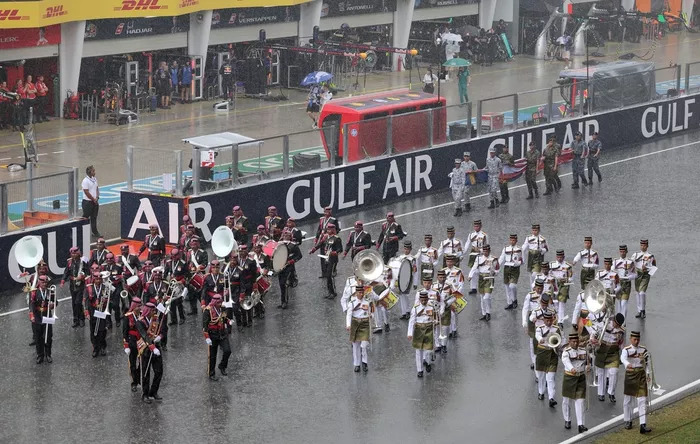 Marching bands perform on the grid.