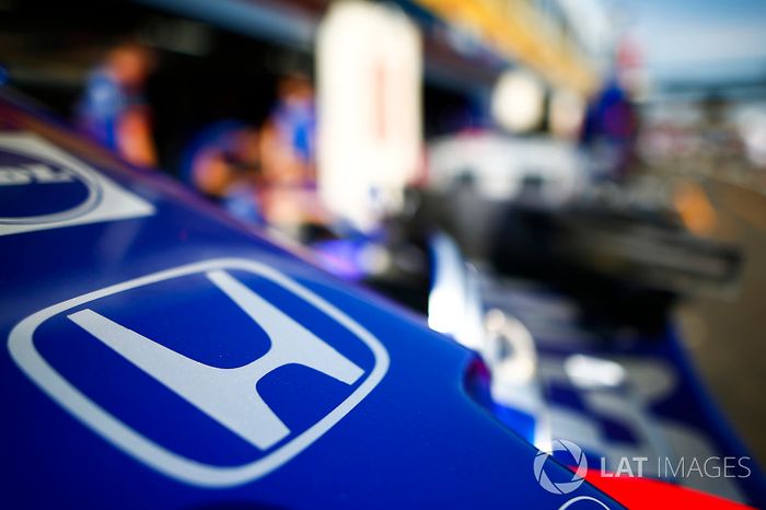 A Honda logo on the nose of a Toro Rosso in the pit lane