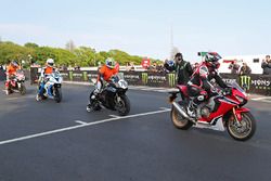 Isle of Man TT Rider Liaison officer Richard Milky Quayle gets proceedings underway by taking the Newcomers on their speed-controlled lap of the Mountain Course