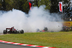 Pierre Gasly, Toro Rosso STR13, and Nico Hulkenberg, Renault Sport F1 Team R.S. 18, collect the spinning Romain Grosjean, Haas F1 Team VF-18