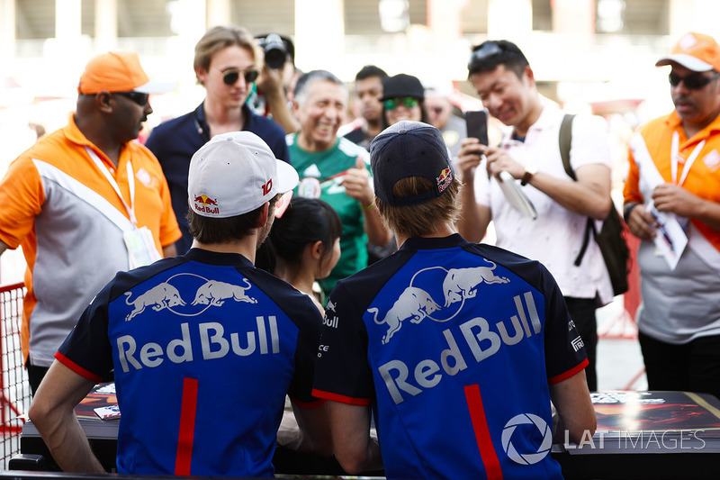 Pierre Gasly, Toro Rosso, and Brendon Hartley, Toro Rosso, sign autographs for fans