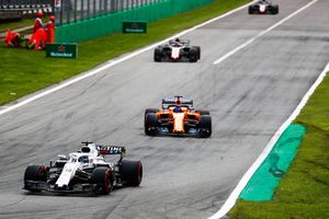 Lance Stroll, Williams FW41, leads Fernando Alonso, McLaren MCL33, and Kevin Magnussen, Haas F1 Team VF-18