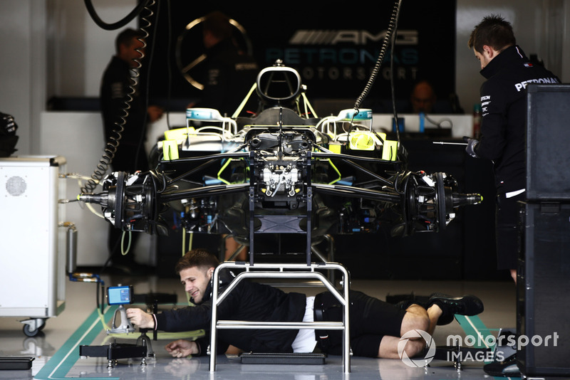 Mechanics work on a Mercedes AMG F1 W09 EQ Power + in the garage.