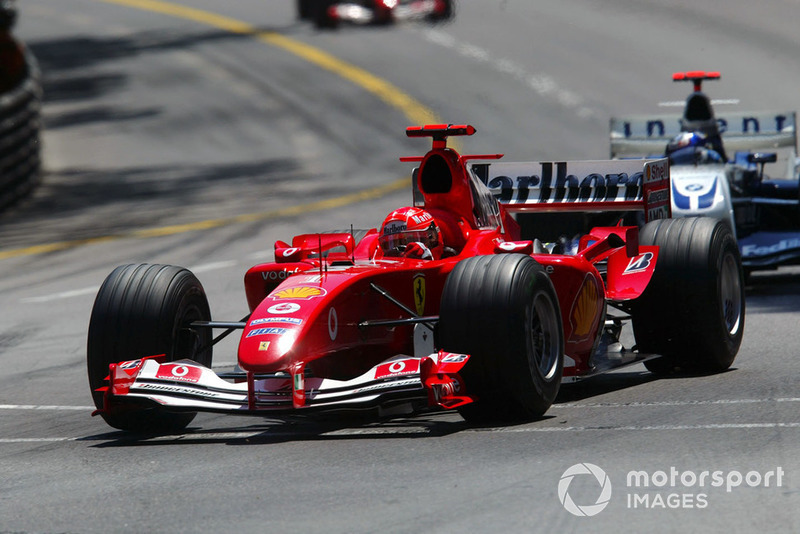 Pembalap Scuderia Ferrari, Michael Schumacher, juara dunia F1 2004 usai memenangi 13 dari 18 balapan musim tersebut. Tampak Schumi di depan Juan Pablo Montoya yang mengendarai Williams BMW FW26 di GP Monaco 2004.