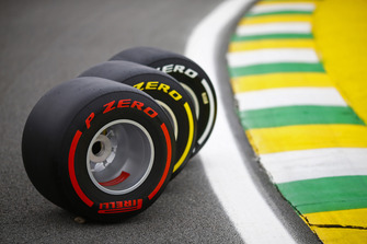 Three Pirelli tyres are displayed on the track