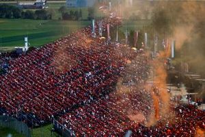 A sea of orange and orange smoke flares in a grandstand in support of Dutchman Max Verstappen, Red Bull Racing