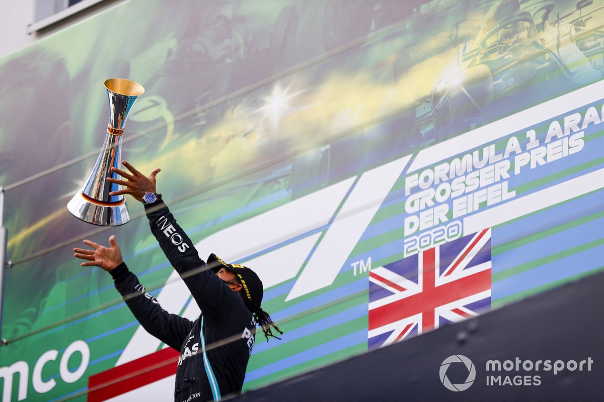 Lewis Hamilton, Mercedes-AMG F1, 1st position, tosses his trophy in the air in celebration on the podium