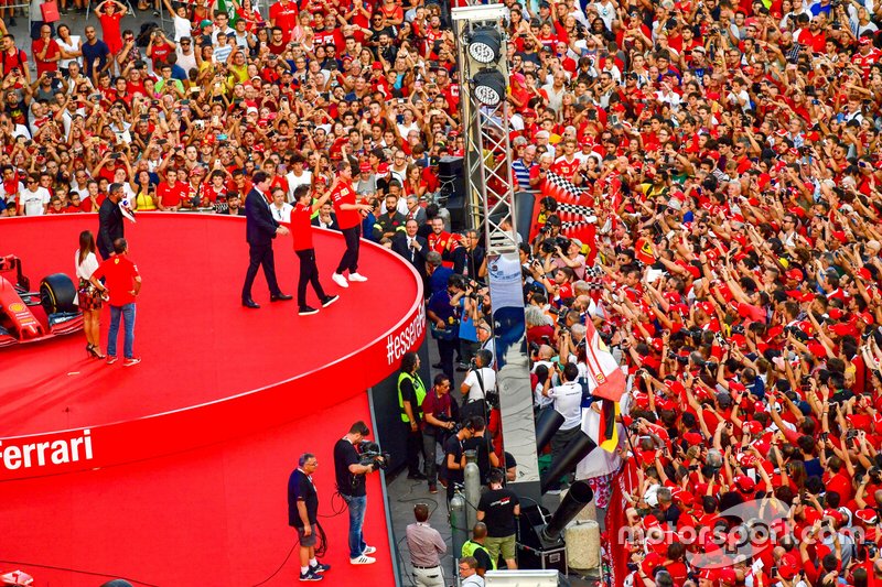Charles Leclerc, Ferrari and Sebastian Vettel, Ferrari wave to the crowd from the stage