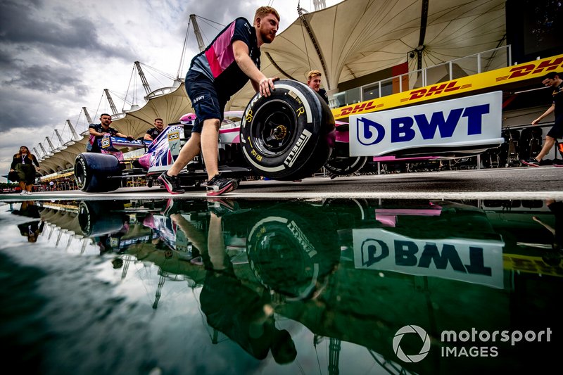 Racing Point mechanics pushing the car of Sergio Perez, Racing Point RP19 down the pit lane