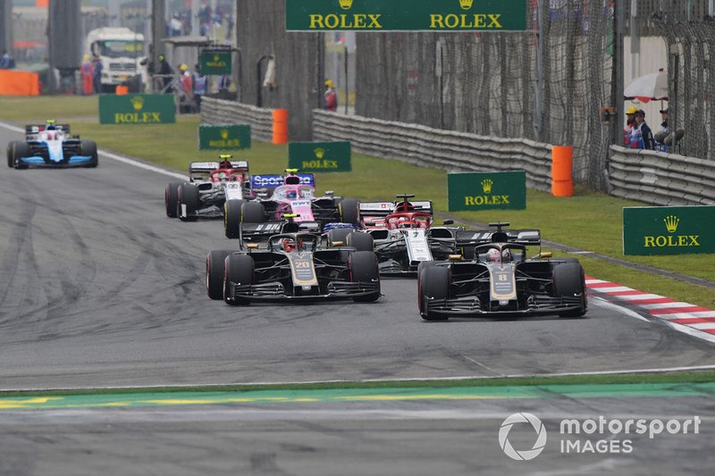 Romain Grosjean, Haas F1 Team VF-19, leads Kevin Magnussen, Haas F1 Team VF-19, Kimi Raikkonen, Alfa Romeo Racing C38, Lance Stroll, Racing Point RP19, Antonio Giovinazzi, Alfa Romeo Racing C38, and Robert Kubica, Williams FW42, on the opening lap