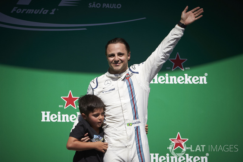 Felipe Massa, Williams, with his son Felipinho waves to his home fans from the podium after his fina