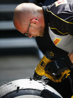 A Pirelli engineer works on some tyres