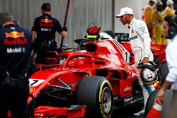 Lewis Hamilton, Mercedes AMG F1, studies the Kimi Raikkonen, Ferrari, after qualifying