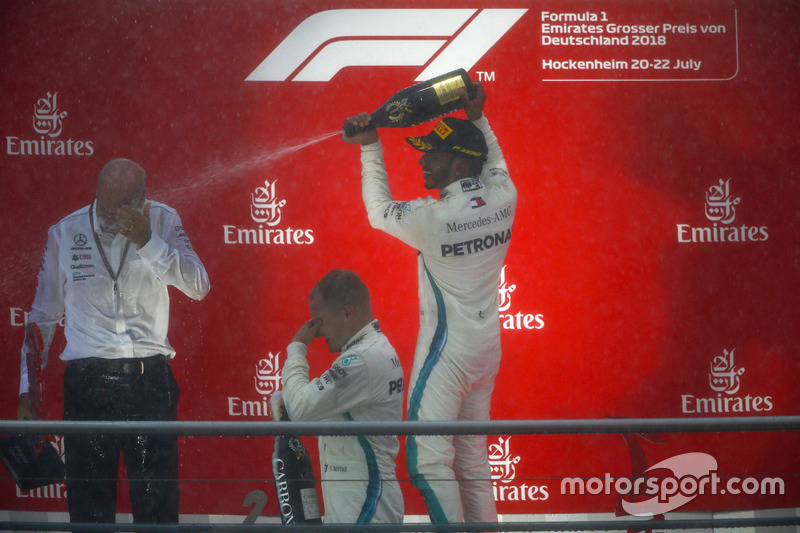 Race winner Lewis Hamilton, Mercedes AMG F1, second place Valtteri Bottas, Mercedes AMG F1, and Dr Dieter Zetsche, CEO, Mercedes Benz, celebrate with Champagne on the podium
