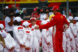 Kimi Raikkonen, Ferrari, with the grid kids