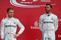 (L to R): Nico Rosberg, Mercedes AMG F1 on the podium with team mate Lewis Hamilton, Mercedes AMG F1