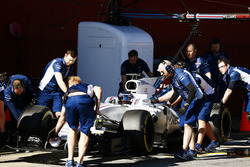 Lance Stroll, Williams FW40, is wheeled back into his garage by team members
