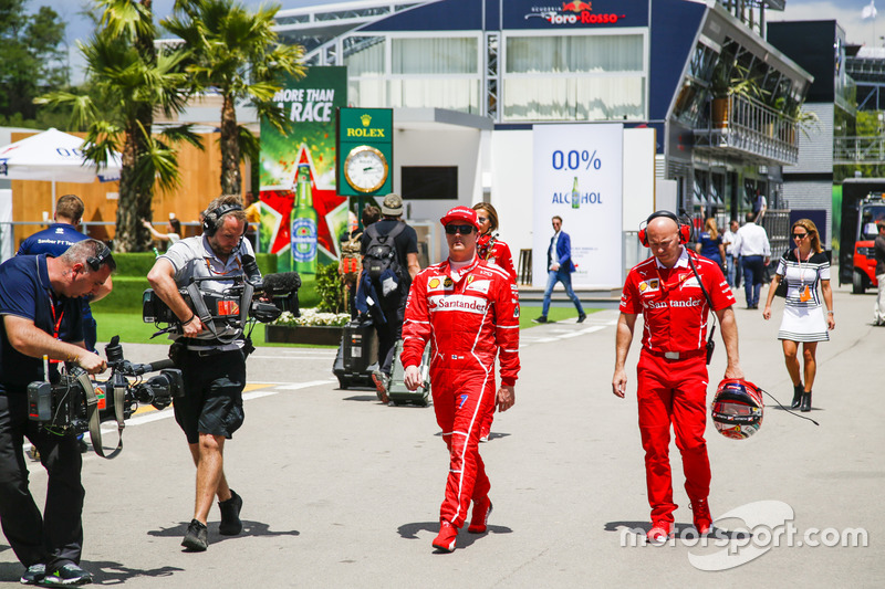 Kimi Raikkonen, Ferrari, heads back to the garage on foot after retiring