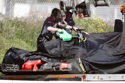 Romain Grosjean's Haas F1 Team VF-17 is returned to the pits