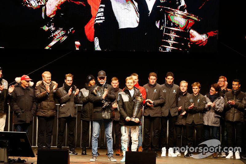 World Champion Nico Rosberg celebrates with the team and Chairman of the Board of Directors of Daiml