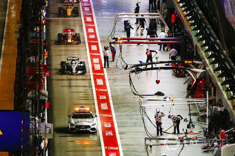 The Safety Car leads Lewis Hamilton, Mercedes AMG F1 W08, the rest of the field through the pit lane