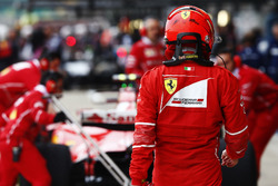 Ferrari team members work on the Kimi Raikkonen Ferrari SF70H in the pit lane