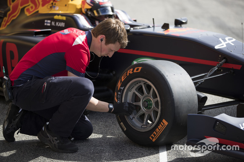 A mechanic checks the GP3 Pirelli tyres of Niko Kari, Arden International