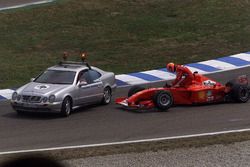 Michael Schumacher, Ferrari F2001, climbs out of his wrecked car