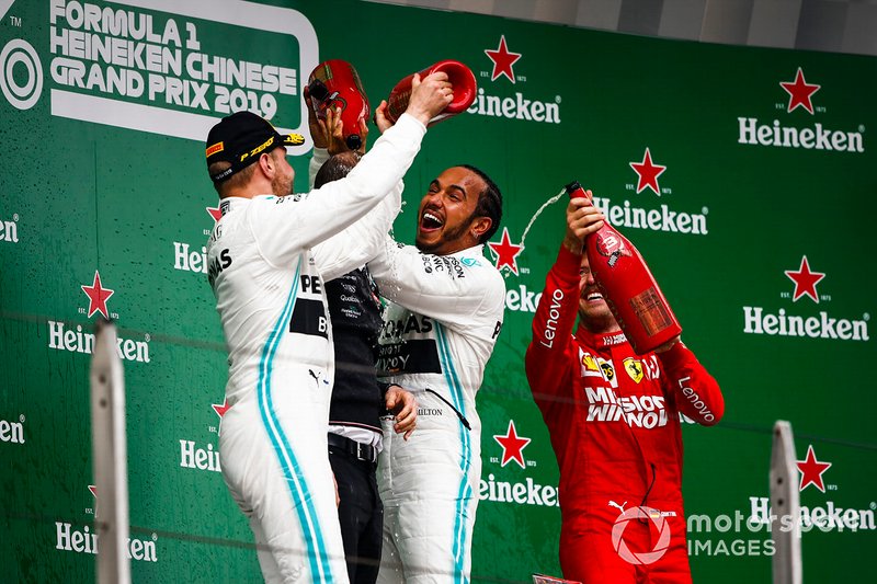 Valtteri Bottas, Mercedes AMG F1, 2nd position, Lewis Hamilton, Mercedes AMG F1, 1st position, and Sebastian Vettel, Ferrari, 3rd position, on the podium