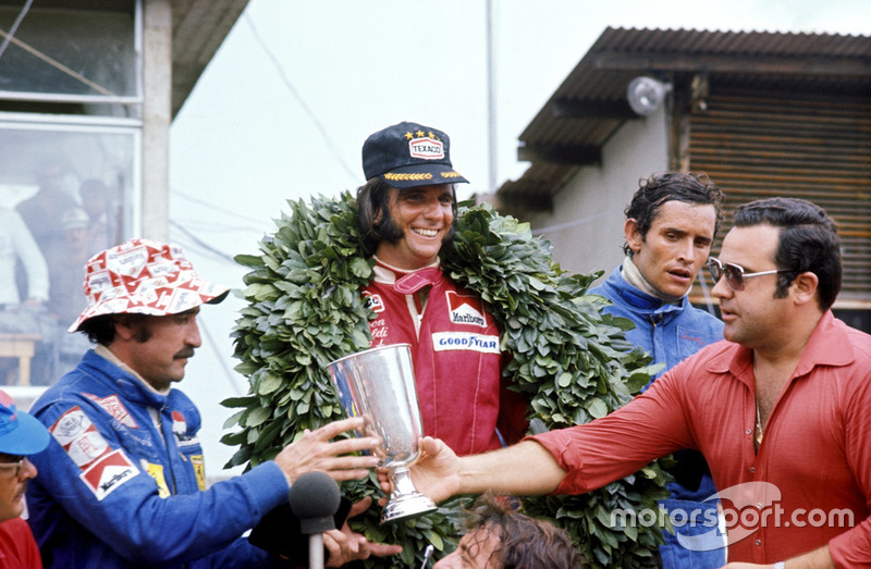 The podium (L to R): Clay Regazzoni, Ferrari second; Emerson Fittipaldi, McLaren winner; Jacky Ickx, Lotus third.