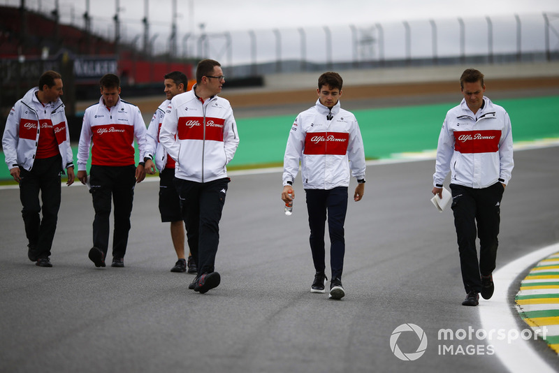Charles Leclerc, Sauber, walks the circuit with colleagues