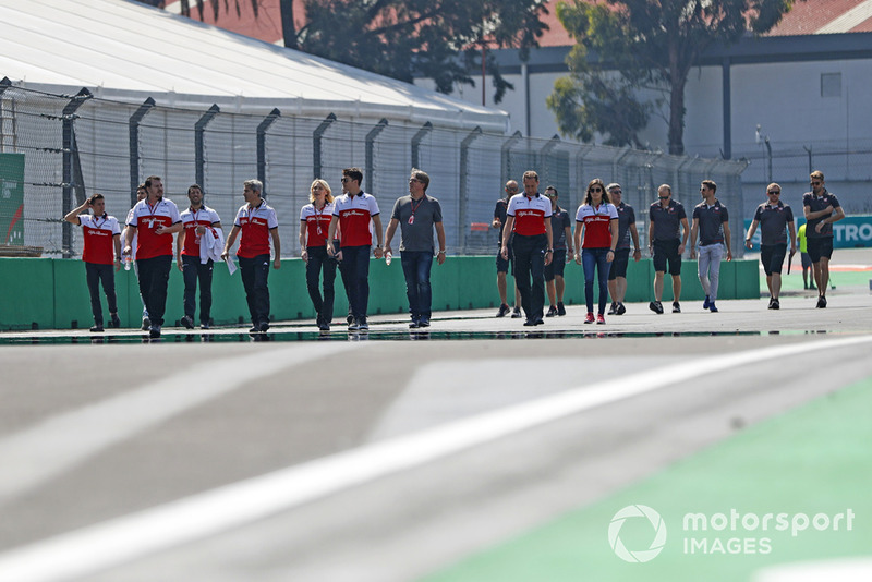 Charles Leclerc, Sauber, walks the circuit with colleagues