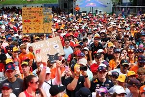 Fans gather by the fan forums stage.