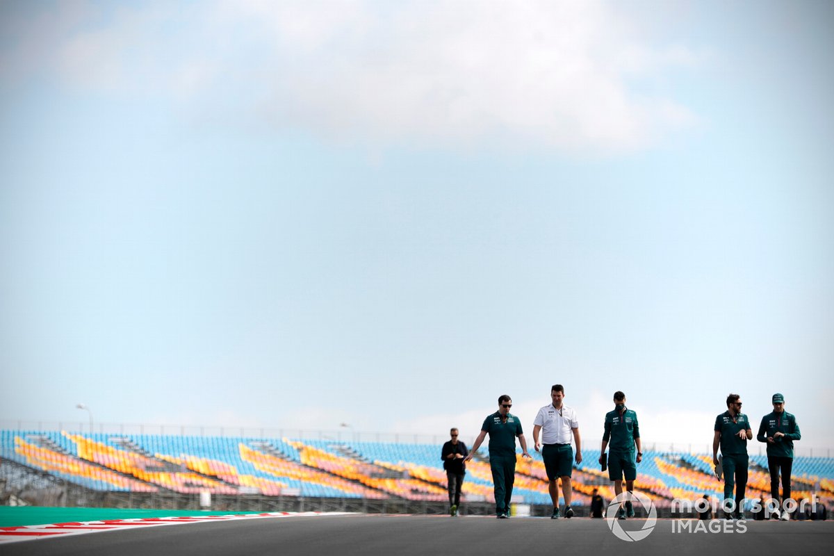 Lance Stroll, Aston Martin, walks the track with members of his team